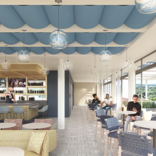 The image shows a modern bar with a seating area, overhead lights, and people enjoying drinks near large windows with an outdoor view.